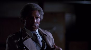 Movie still from “Sharky's Machine” (1981), directed by Burt Reynolds – An older man wearing a suit and tie; Close Up shot, Low angle