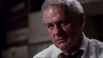 Movie still from “Sharky's Machine” (1981), directed by Burt Reynolds – An older man wearing a white shirt and a bow tie; Close Up shot, Low angle