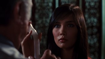 Movie still from “Sharky's Machine” (1981), directed by Burt Reynolds – A beautiful young woman holding a remote control; Close Up shot, Over the shoulder angle