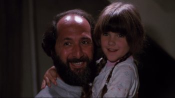 Movie still from “Sharky's Machine” (1981), directed by Burt Reynolds – A man and a little girl smiling for the camera; Close Up shot, High angle