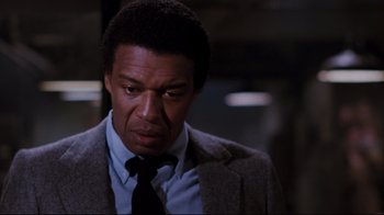 Movie still from “Sharky's Machine” (1981), directed by Burt Reynolds – A man in a suit and a tie; Close Up shot, Low angle