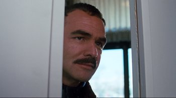 Movie still from “Sharky's Machine” (1981), directed by Burt Reynolds – A person with a mustache; Close Up shot, Low angle