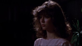 Movie still from “Sharky's Machine” (1981), directed by Burt Reynolds – A woman with long brown hair wearing a pink shirt; Close Up shot, Low angle
