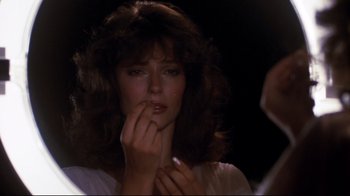 Movie still from “Sharky's Machine” (1981), directed by Burt Reynolds – A person holding their hand to her mouth; Close Up shot, Over the shoulder angle