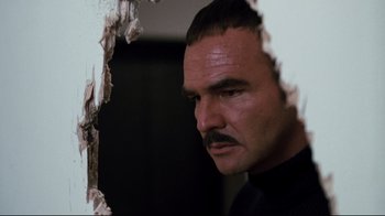 Movie still from “Sharky's Machine” (1981), directed by Burt Reynolds – A person with a mustache; Close Up shot, Low angle