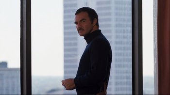 Movie still from “Sharky's Machine” (1981), directed by Burt Reynolds – A man standing in front of a large building; Medium shot, Low angle