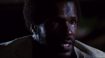 Movie still from “Sharky's Machine” (1981), directed by Burt Reynolds – A man's face in the dark; Close Up shot, Low angle