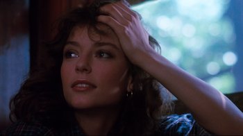 Movie still from “Sharky's Machine” (1981), directed by Burt Reynolds – A person holding their hand on her head; Close Up shot, Over the shoulder angle