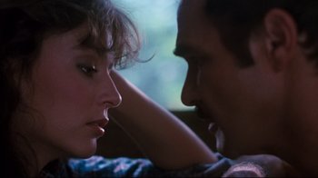 Movie still from “Sharky's Machine” (1981), directed by Burt Reynolds – A man and a woman sitting next to each other on a couch; Close Up shot, Over the shoulder angle