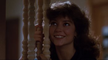 Movie still from “Sharky's Machine” (1981), directed by Burt Reynolds – A woman holding onto a wooden railing; Close Up shot, Low angle
