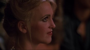 Movie still from “Sharky's Machine” (1981), directed by Burt Reynolds – A woman's face in a dark room; Close Up shot, Over the shoulder angle