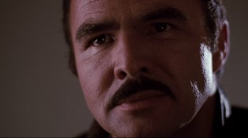 Movie still from “Sharky's Machine” (1981), directed by Burt Reynolds – A man with a mustache; Close Up shot, Low angle