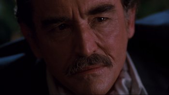 Movie still from “Sharky's Machine” (1981), directed by Burt Reynolds – A man with a mustache; Close Up shot, Over the shoulder angle