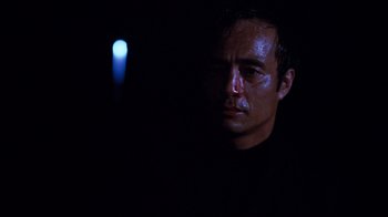 Movie still from “Sharky's Machine” (1981), directed by Burt Reynolds – A person wearing a black shirt; Close Up shot, Low angle