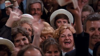 Movie still from “Sharky's Machine” (1981), directed by Burt Reynolds – A group of people in a crowd wearing hats; Medium shot, High angle