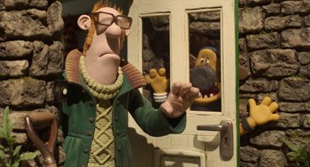 Movie still from “Shaun the Sheep Movie” (2015), directed by Mark Burton – A man in a green jacket and a dog in a doorway; Medium shot, Over the shoulder angle