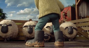 Movie still from “Shaun the Sheep Movie” (2015), directed by Mark Burton – A person standing in front of a herd of sheep; Wide shot, Low angle