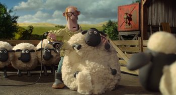 Movie still from “Shaun the Sheep Movie” (2015), directed by Mark Burton – A man and a stuffed sheep in a scene from wallace and gromit's world of aardman; Wide shot, High angle