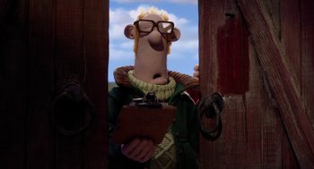 Movie still from “Shaun the Sheep Movie” (2015), directed by Mark Burton – A man with a clipboard standing in a doorway; Medium shot, Low angle