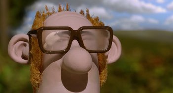 Movie still from “Shaun the Sheep Movie” (2015), directed by Mark Burton – The face of a cartoon character with glasses; Close Up shot, Low angle