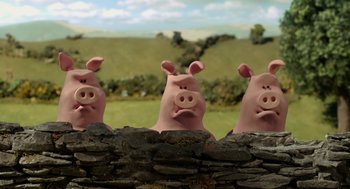 Movie still from “Shaun the Sheep Movie” (2015), directed by Mark Burton – A group of three pigs standing next to each other on top of a stone wall; Medium shot, Low angle