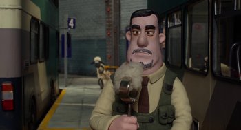 Movie still from “Shaun the Sheep Movie” (2015), directed by Mark Burton – A man with a brush in his mouth; Medium shot, Over the shoulder angle