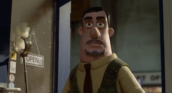 Movie still from “Shaun the Sheep Movie” (2015), directed by Mark Burton – An animated man with a mustache wearing a brown tie; Close Up shot, Over the shoulder angle