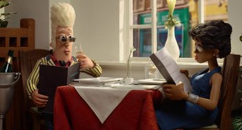 Movie still from “Shaun the Sheep Movie” (2015), directed by Mark Burton – Two people sitting at a table with a glass of wine; Medium shot, Over the shoulder angle