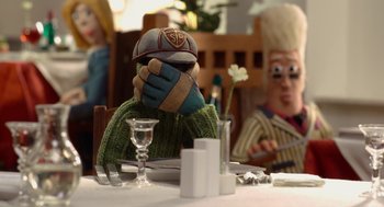 Movie still from “Shaun the Sheep Movie” (2015), directed by Mark Burton – Two people sitting at a table with a stuffed animal; Close Up shot, Over the shoulder angle