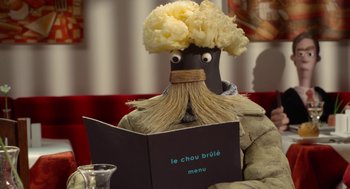 Movie still from “Shaun the Sheep Movie” (2015), directed by Mark Burton – A person with a beard and a mustache is reading a menu in front of him; Close Up shot, Over the shoulder angle