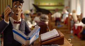 Movie still from “Shaun the Sheep Movie” (2015), directed by Mark Burton – A man reading a book at the table; Medium shot, High angle