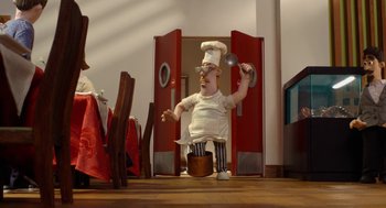 Movie still from “Shaun the Sheep Movie” (2015), directed by Mark Burton – An animated character is holding a frying pan; Wide shot, Low angle