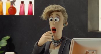 Movie still from “Shaun the Sheep Movie” (2015), directed by Mark Burton – A person's face with a surprised look on their face; Close Up shot, Over the shoulder angle