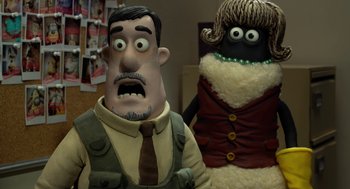Movie still from “Shaun the Sheep Movie” (2015), directed by Mark Burton – A man and a woman are standing next to each other; Close Up shot, Over the shoulder angle