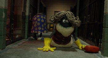 Movie still from “Shaun the Sheep Movie” (2015), directed by Mark Burton – A stuffed animal dressed as a woman sitting on the ground; Wide shot, High angle
