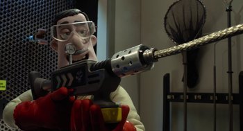 Movie still from “Shaun the Sheep Movie” (2015), directed by Mark Burton – A man holding a drill and wearing goggles and gloves; Close Up shot, Low angle