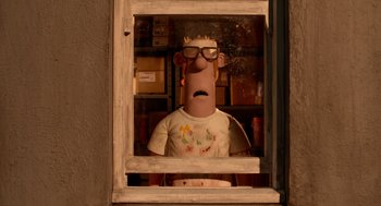 Movie still from “Shaun the Sheep Movie” (2015), directed by Mark Burton – A man with glasses is looking out of a window; Medium shot, Low angle