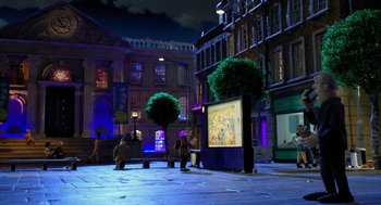 Movie still from “Shaun the Sheep Movie” (2015), directed by Mark Burton – People are sitting on benches in front of a large screen; Extreme Wide shot, High angle