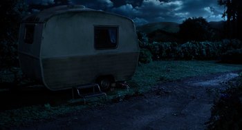 Movie still from “Shaun the Sheep Movie” (2015), directed by Mark Burton – An old trailer parked on the side of the road; Extreme Wide shot, High angle