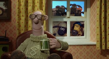 Movie still from “Shaun the Sheep Movie” (2015), directed by Mark Burton – A man in a sweater holding a cup in front of a window; Wide shot, Over the shoulder angle