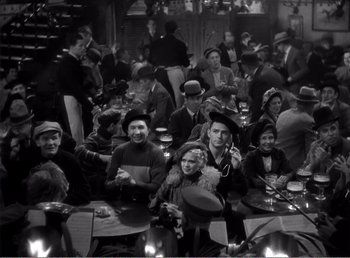 A group of people sitting at a table with hats on