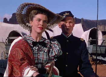 Movie still from “She Wore a Yellow Ribbon” (1949), directed by John Ford – A man and a woman dressed in period clothing; Medium shot, Low angle