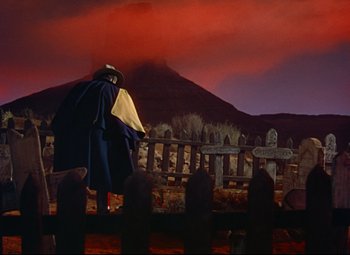 Movie still from “She Wore a Yellow Ribbon” (1949), directed by John Ford – An image of a graveyard with a person in the background; Wide shot, Low angle