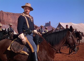 Movie still from “She Wore a Yellow Ribbon” (1949), directed by John Ford – A man dressed as a civil war soldier on horseback; Medium shot, Low angle