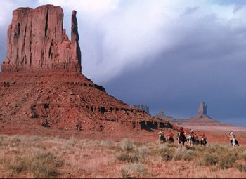 Movie still from “She Wore a Yellow Ribbon” (1949), directed by John Ford – A group of people riding horses in the desert; Extreme Wide shot, Low angle