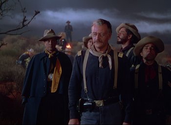 Movie still from “She Wore a Yellow Ribbon” (1949), directed by John Ford – A group of men standing next to each other in a field; Medium shot, Low angle
