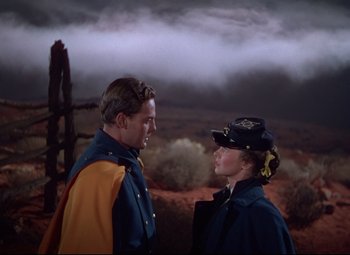 Movie still from “She Wore a Yellow Ribbon” (1949), directed by John Ford – A man and a woman standing next to each other; Medium shot, Low angle