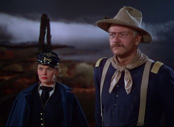 Movie still from “She Wore a Yellow Ribbon” (1949), directed by John Ford – A man and a woman standing next to each other; Medium shot, Low angle
