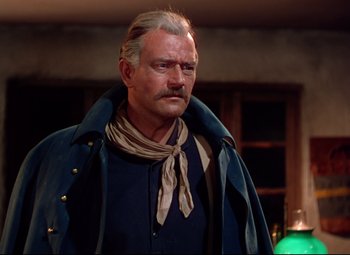 Movie still from “She Wore a Yellow Ribbon” (1949), directed by John Ford – An older man with a mustache wearing a blue jacket; Medium shot, Over the shoulder angle