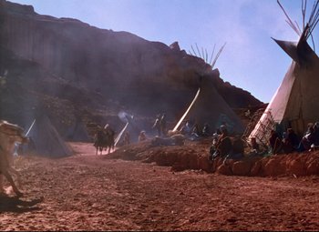 Movie still from “She Wore a Yellow Ribbon” (1949), directed by John Ford – A group of people riding horses in a field; Extreme Wide shot, High angle